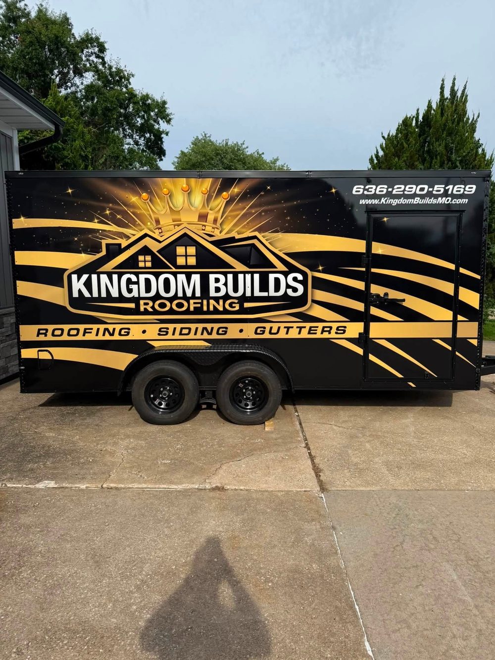 Black and gold full wrap on an enclosed trailer for Kingdom Builds Roofing