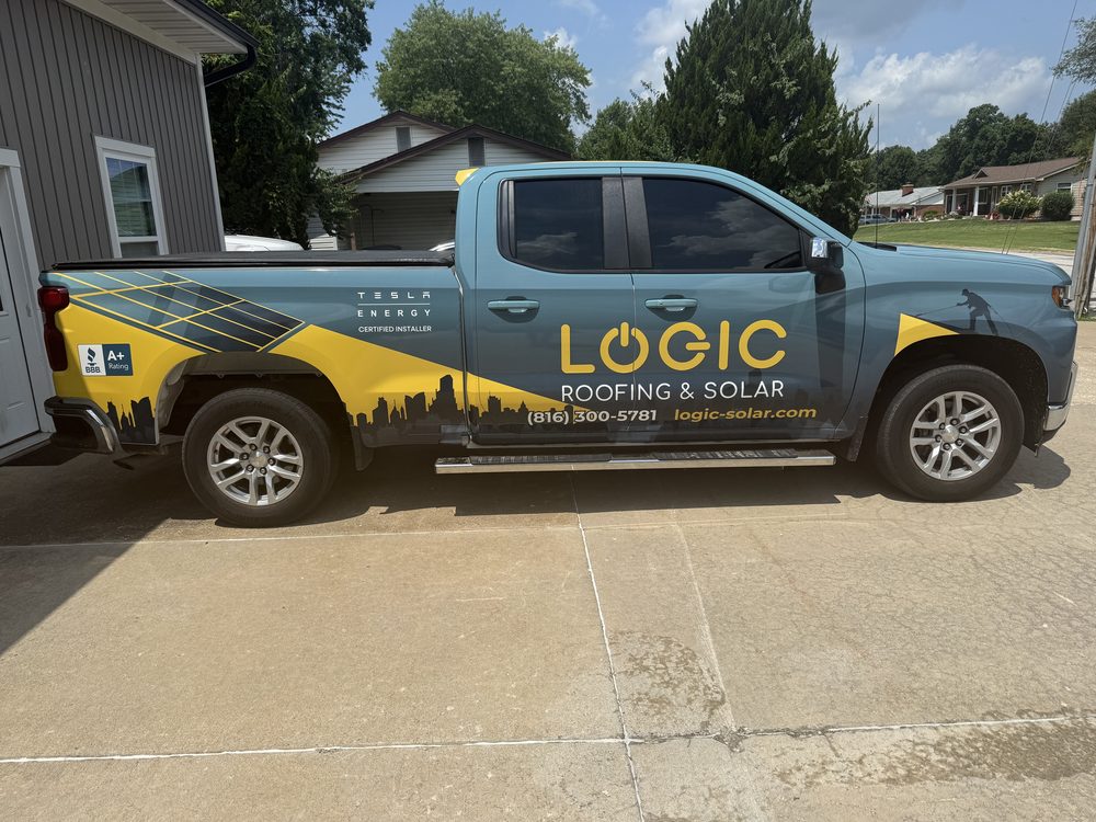 Teal and yellow full wrap on a Chevrolet Silverado for Logic Roofing and Solar, a certified Tesla Energy installer