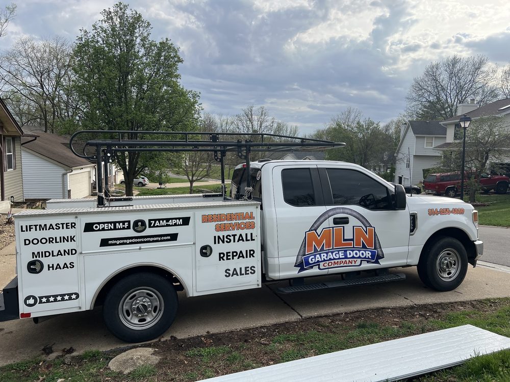 White Ford utility service truck wrapped for MLN Garage Door Company listing install, repair, and sales